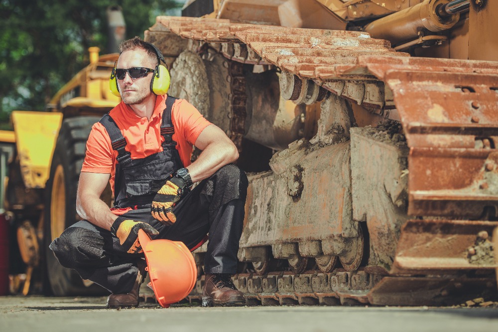 homme à coté d'un bulldozer homme à coté d'un bulldozer